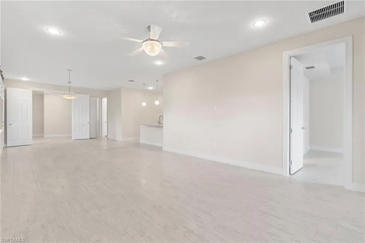 Unfurnished living room with baseboards, visible vents, recessed lighting, and a ceiling fan