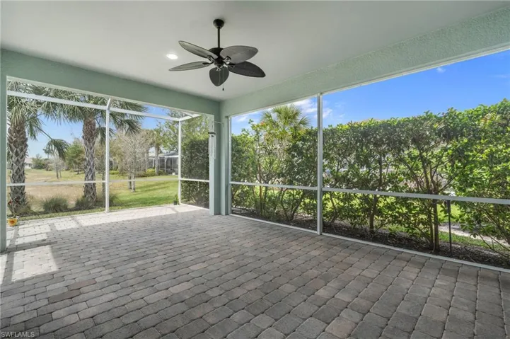 Unfurnished sunroom with ceiling fan