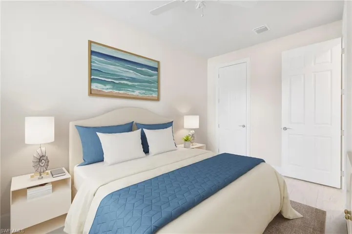 Bedroom with visible vents, wood finished floors, and a ceiling fan