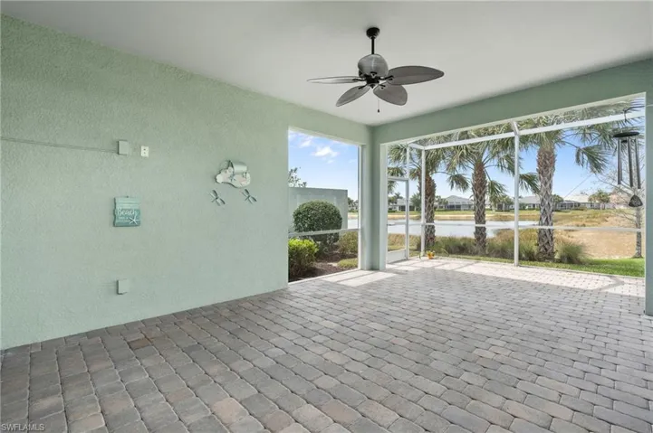 Unfurnished sunroom featuring ceiling fan