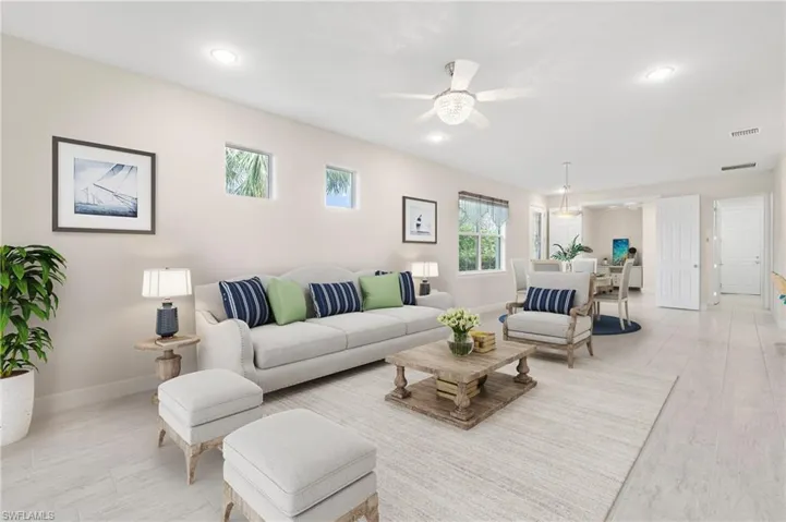 Living room featuring recessed lighting, visible vents, baseboards, and ceiling fan