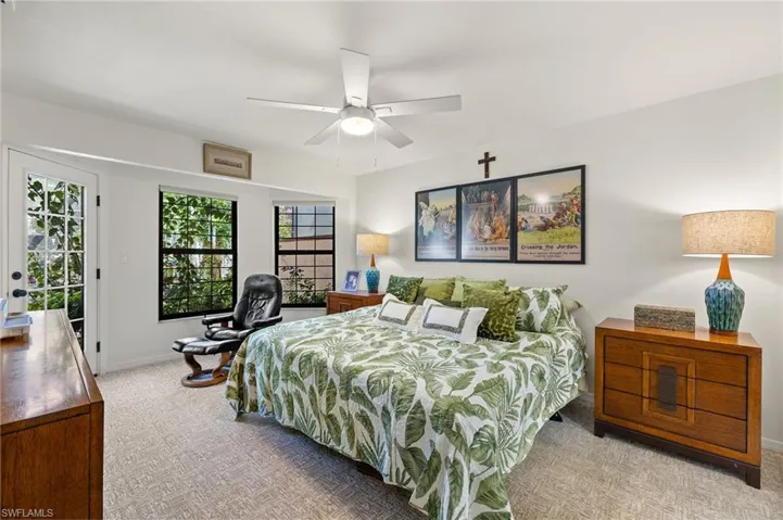 Bedroom featuring baseboards, light carpet, access to exterior, and a ceiling fan
