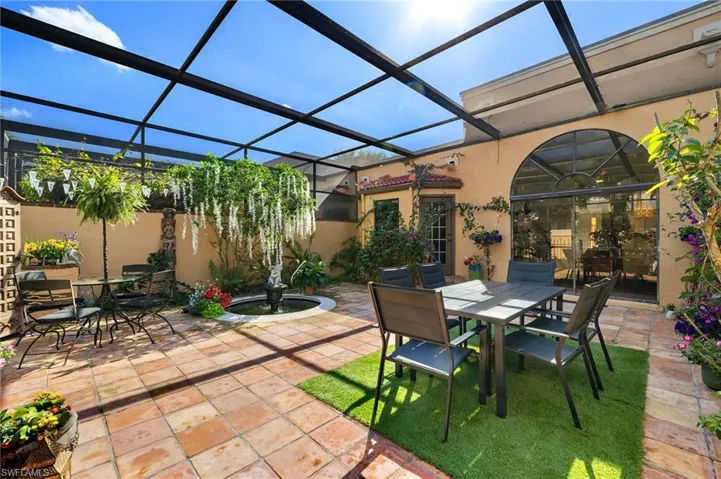 View of patio featuring a lanai, Koi Fish and outdoor dining area