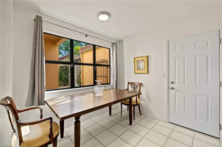 Dining room with light tile patterned flooring and baseboards