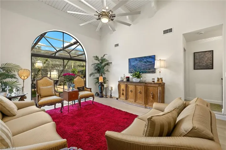 Living area with visible vents, a ceiling fan, and wood finished floors
