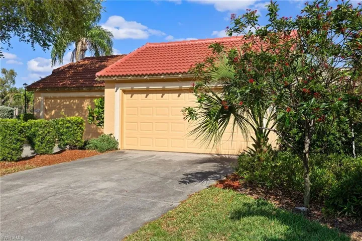 Mediterranean / spanish house featuring concrete driveway, an attached garage, a tile roof, and stucco siding