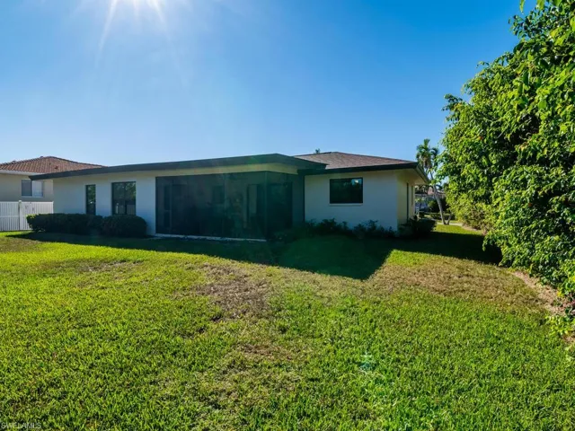 Back of house featuring a lawn