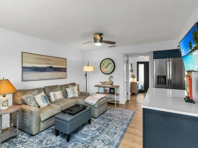 Living room featuring ceiling fan, a healthy amount of sunlight, and light wood-type flooring