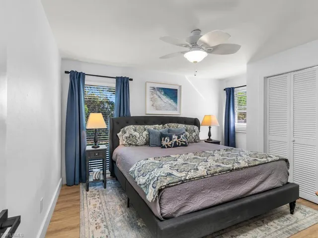 Bedroom featuring hardwood / wood-style floors, ceiling fan, and a closet