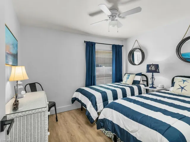 Bedroom featuring ceiling fan and light hardwood / wood-style flooring