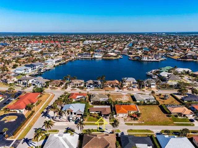Birds eye view of property with a water view