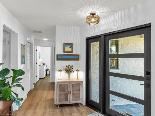 Foyer entrance featuring plenty of natural light and light hardwood / wood-style flooring