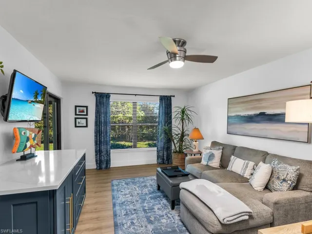 Living room featuring ceiling fan and light wood-type flooring