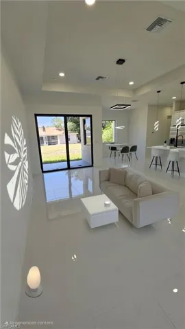 Living room featuring recessed lighting and a raised ceiling