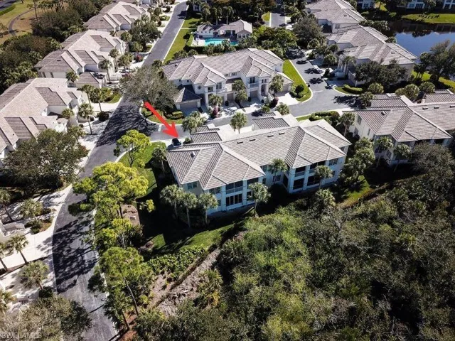 Aerial perspective of suburban area featuring a large body of water
