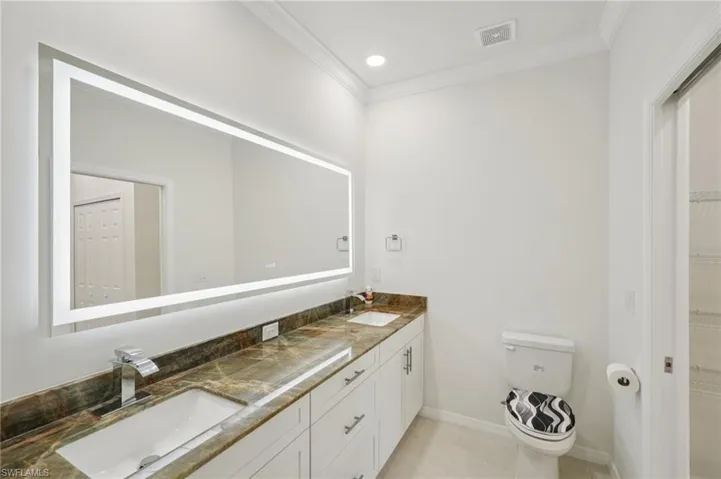 Full bathroom featuring ornamental molding, light tile patterned flooring, recessed lighting, and a walk in closet