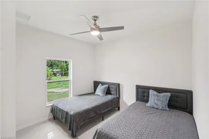 Bedroom featuring a ceiling fan and baseboards