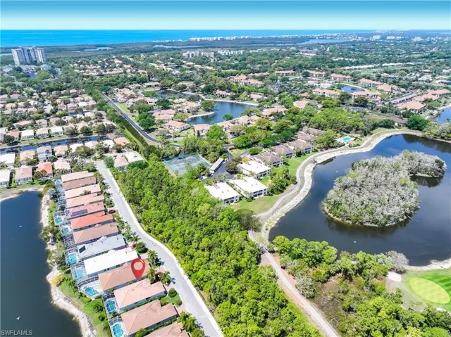 Aerial perspective of suburban area featuring a large body of water