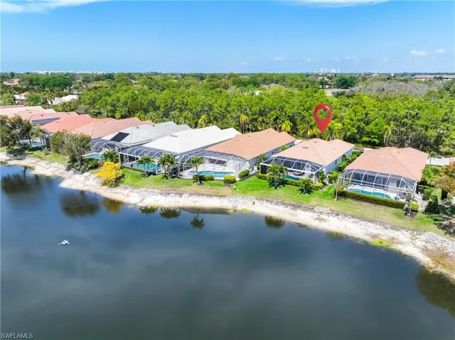Aerial perspective of suburban area featuring a nearby body of water