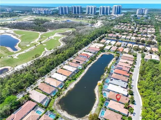 Aerial overview of property's location with a large body of water and nearby suburban area