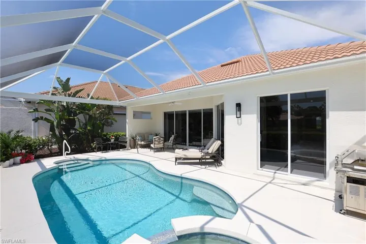 Integrated pool / spa with a patio, a sunroom, a lanai, and a grill