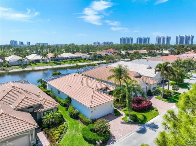 Aerial view of residential area featuring skyline and a large body of water