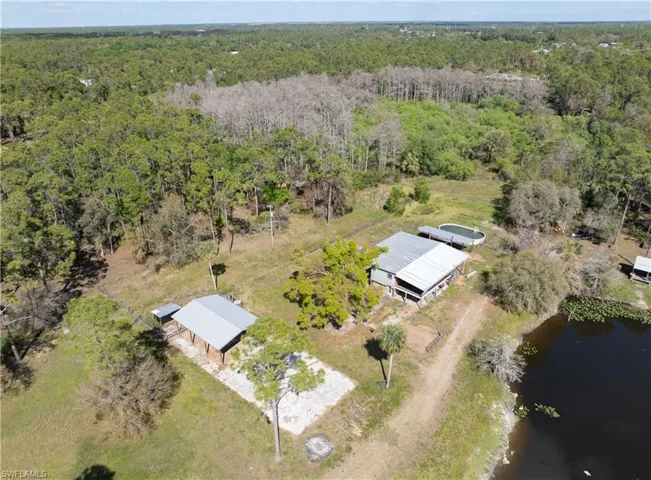 Aerial view with a forest view and a water view