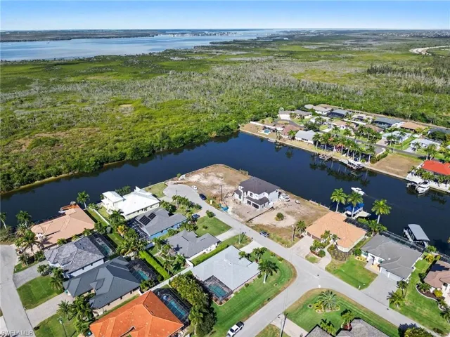 Aerial view of property and Aerial view of property and surrounding area with a nearby Gulf Acess homes and spreader canal