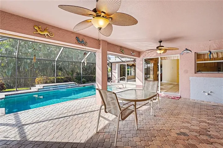 Swimming pool featuring a patio, screened enclosure, and a over sized lanai with plumbing ready for outdoor kitchen