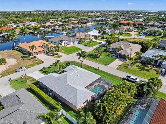 Aerial view of property and surrounding area with a nearby Gulf Acess homes and spreader canal