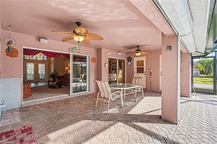 View of patio / terrace featuring outdoor dining area, a ceiling fan, and sliding doors