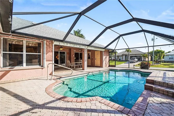 Outdoor pool with a patio, and a lanai