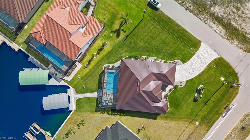 Birds eye view of property featuring a water view and yard space