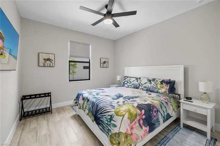 Bedroom with ceiling fan and walk in closet