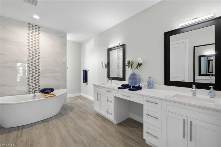 Master Bathroom featuring a soaking tub to relax in, and large 2 sink vanity