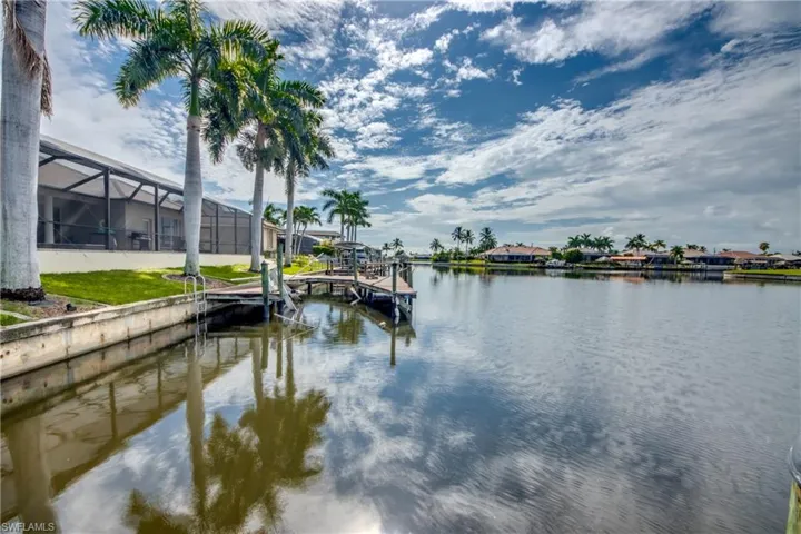 View of dock with a water view and glass enclosure