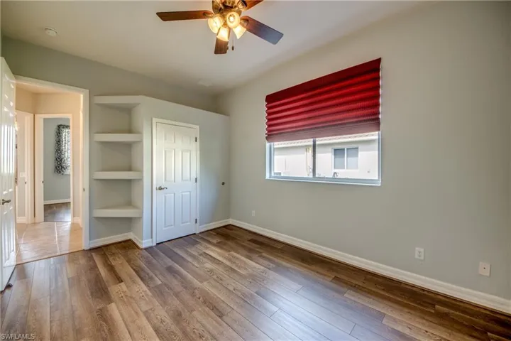 Unfurnished bedroom with ceiling fan and hardwood / wood-style floors