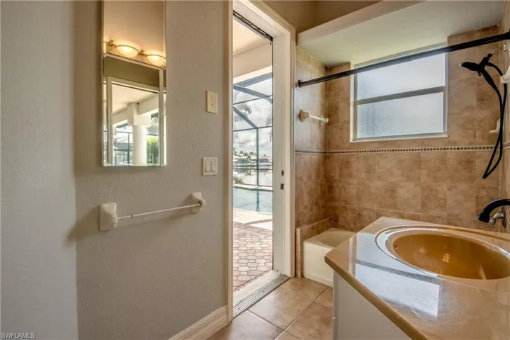 Bathroom with tile patterned flooring, a water view, vanity, and plenty of natural light