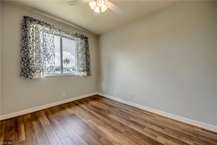 Spare room with ceiling fan and wood-type flooring