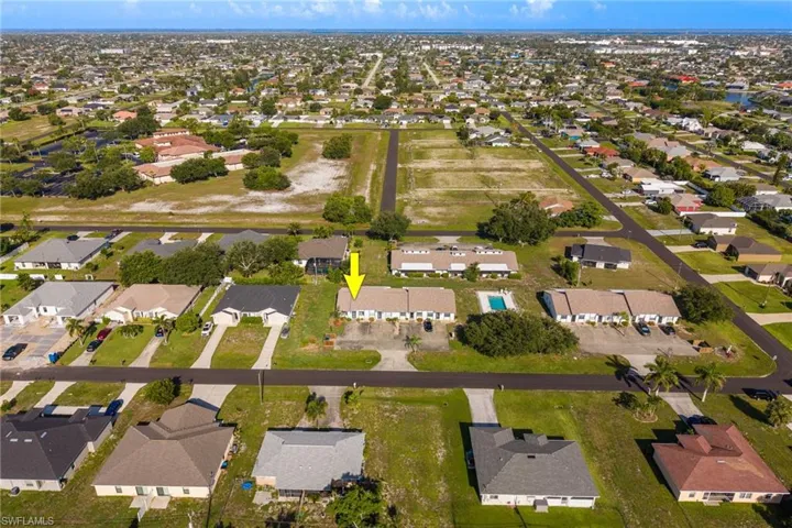 Aerial perspective showcasing a residential community with numerous single-story homes