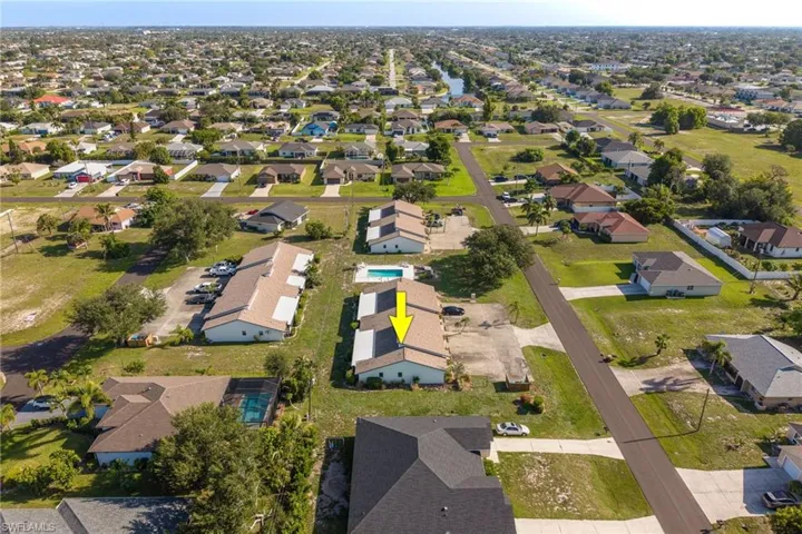 Aerial overview of a residential neighborhood featuring single-story homes and multi-unit buildings