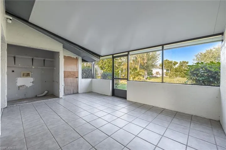 Screened enclosure featuring a tile floor, white ceiling, and expansive windows