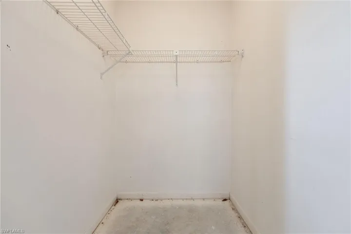 White wire shelving system installed within a closet space
