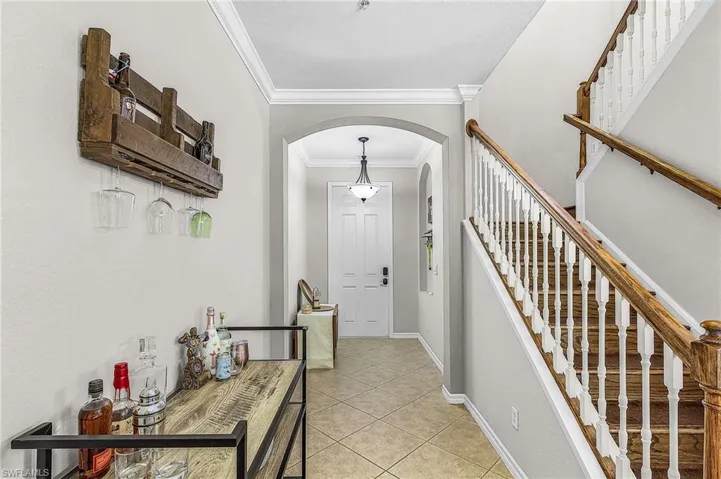 Two-story staircase featuring wood handrails and white balusters