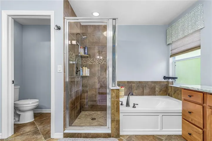 Tiled shower enclosure with glass surround
