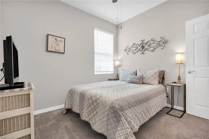 Carpeted bedroom with baseboards
