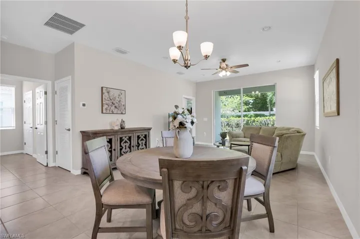 Dining room with a wealth of natural light, visible vents, and light tile patterned floors