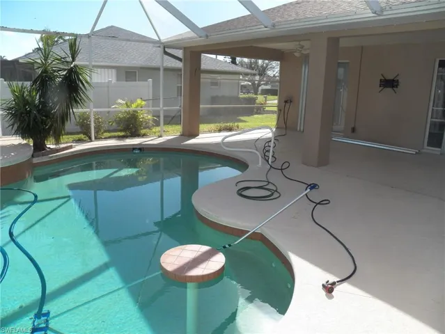 View of swimming pool showing the table and jetted bench