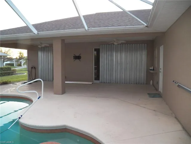 View of pool area, sliders behind hurricane shutters