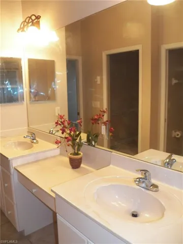 Bathroom with vanity and mirror